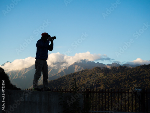 two photographers with cameras in mountains