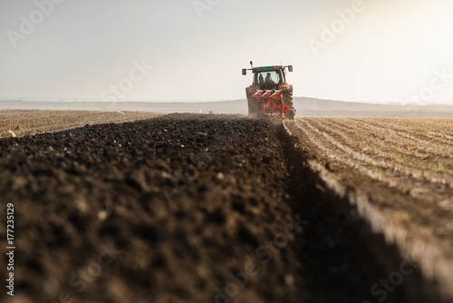 Tractor plowing fields  -preparing land for sowings