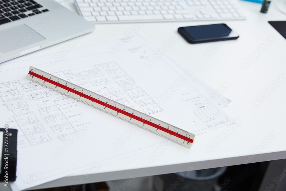 High angle view of blueprints with ruler at desk in creative office High angle view of blueprints with ruler at desk in creative office