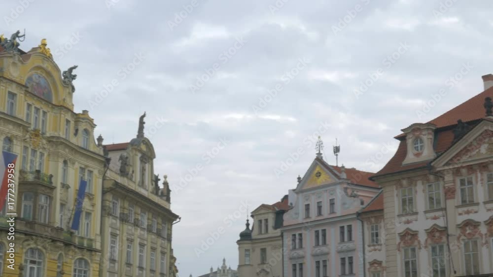 Pan of top of colourful buildings to Jas Hus Statue on Old Town Square in Prague, Czech Republic Pan of top of colourful buildings to Jas Hus Statue on Old Town Square in Prague, Czech Republic