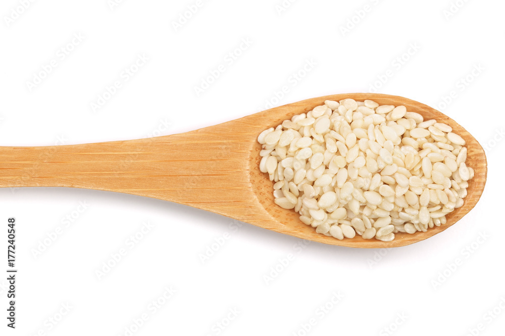 Sesame seeds in a wooden spoon isolated on white background top view Sesame seeds in a wooden spoon isolated on white background top view