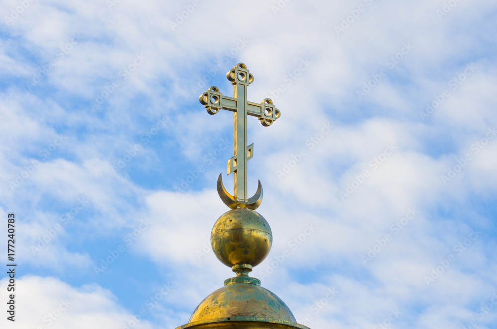 Gold Christian cross on a background of blue sky. Gold Christian cross on a background of blue sky.