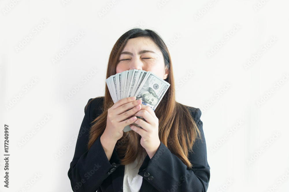 Asian business woman is enjoy with big money US Dollar notes on white background isolated. Asian business woman is enjoy with big money US Dollar notes on white background isolated.