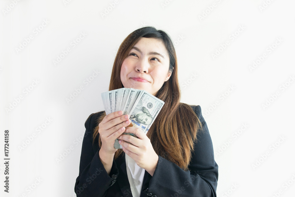 Asian business woman is enjoy with big money US Dollar notes on white background isolated. Asian business woman is enjoy with big money US Dollar notes on white background isolated.