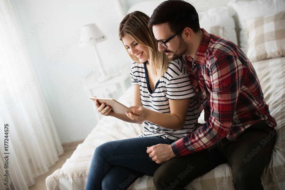 Attractive couple in love using digital tablet Attractive couple in love using digital tablet