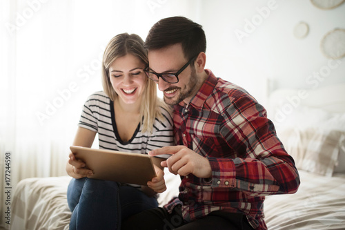 Attractive couple in love using digital tablet