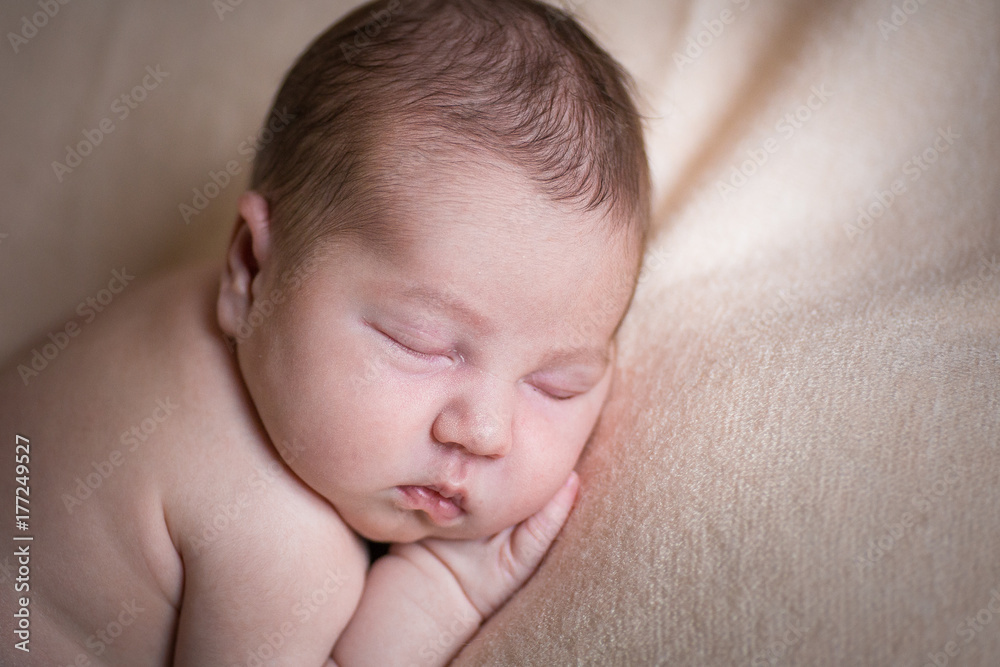 Sleeping newborn baby girl. Sleeping on a covered sheet. Sleeping newborn baby girl. Sleeping on a covered sheet.