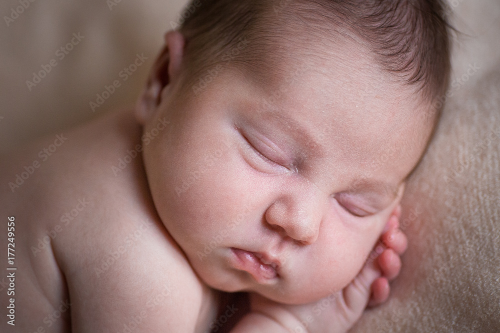 Sleeping newborn baby girl. Sleeping on a covered sheet. Sleeping newborn baby girl. Sleeping on a covered sheet.