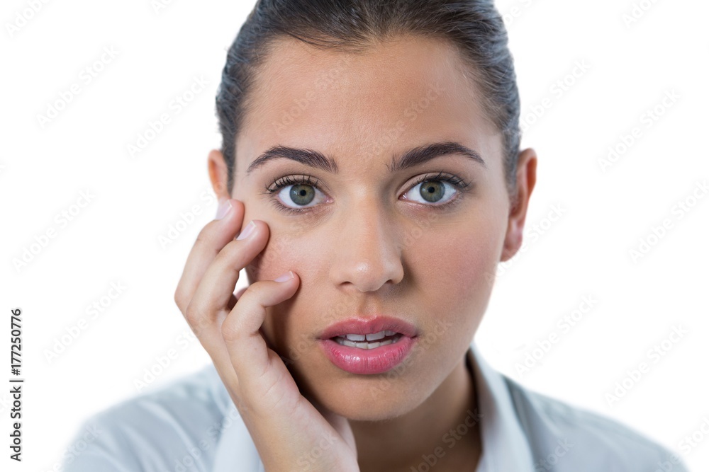 Surprised female executive standing against white background Surprised female executive standing against white background