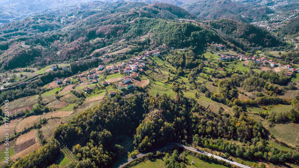 Aerial Shot Of A Small Village Into The Mountain At Autumn
