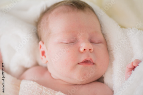 Sleeping newborn baby girl. Sleeping on a covered sheet.