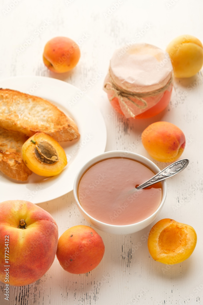 homemade jam of ripe peaches on a white wooden background homemade jam of ripe peaches on a white wooden background
