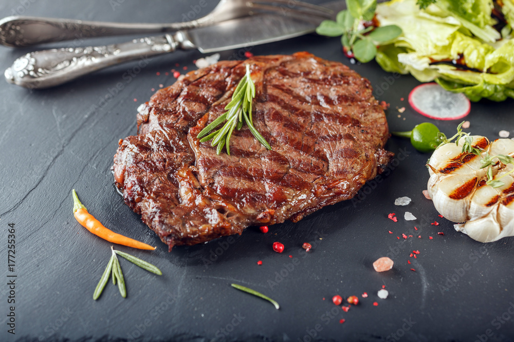 BBQ ribeye steak on a stone Board BBQ ribeye steak on a stone Board