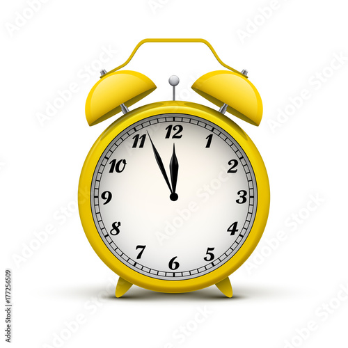 Realistic old yellow alarm clock, isolated on white