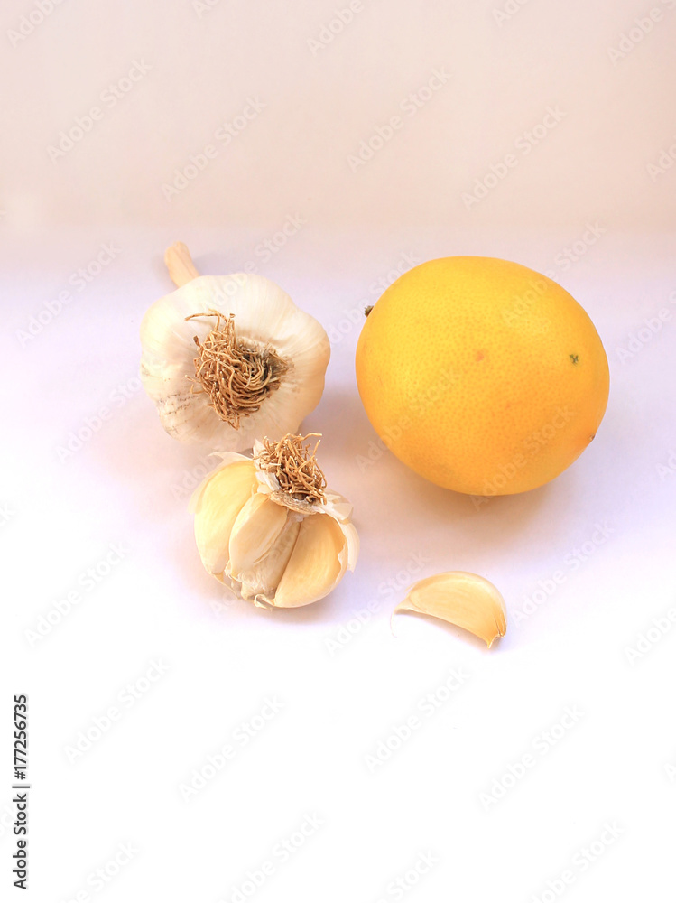 Garlic heads and lemon against colds on a white background Garlic heads and lemon against colds on a white background