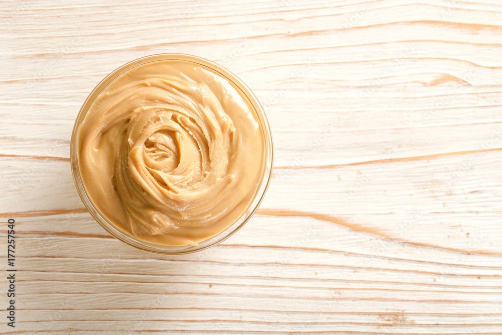 peanuts butter on a wooden background peanuts butter on a wooden background