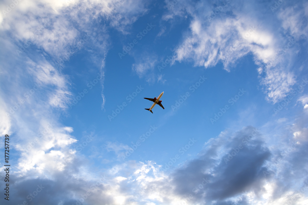 Airplane flying on blue sky. Business travel.
