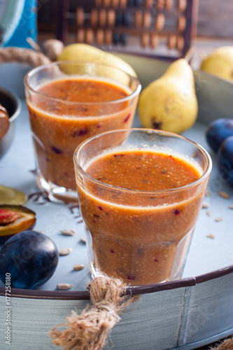 Smoothies with plum, pear, sunflower seeds and honey, selective focus