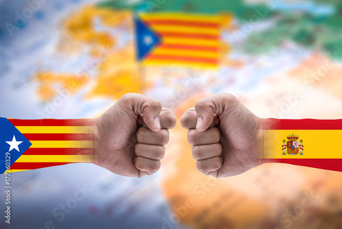 The double exposure image of the isolated arm overlay with Catalonia and Spanish flag and the blurred Catalonia flag image is backdrop. The concept of protesting, and Declaration of independence. photo