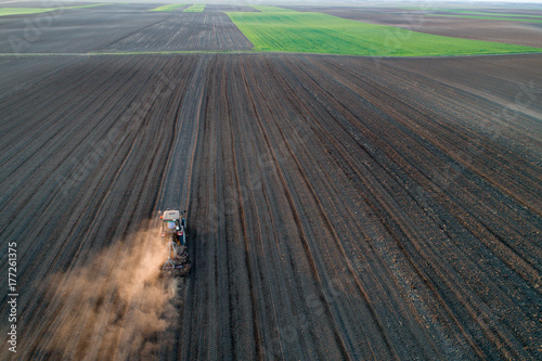 Tractor harrowing soil