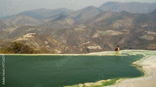 young women siting on the beautiful view in mauntain in mineral spring pool, Mexico Hierve el Agua