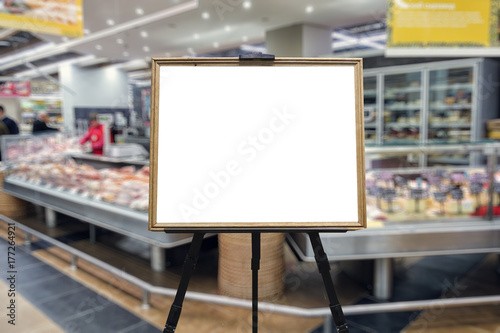 Supermarket, shelves with goods. Defocused image. Place in a wooden frame for your text or advertisement.