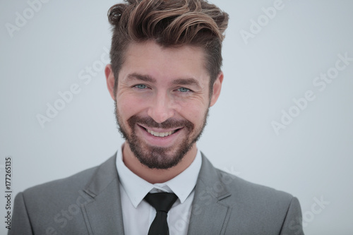 Close up portrait of a smiling handsome business man over white