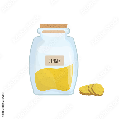 Ground ginger stored in clear jar isolated on white background. Piquant condi...