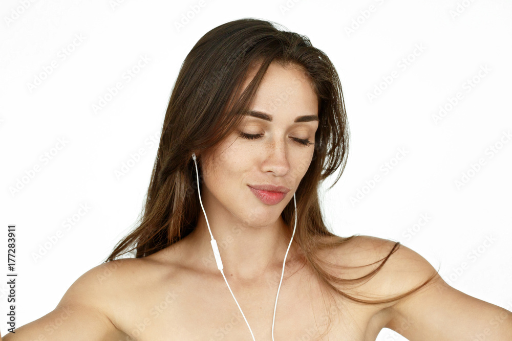 Stunning woman with earphones dances on white background Stunning woman with earphones dances on white background
