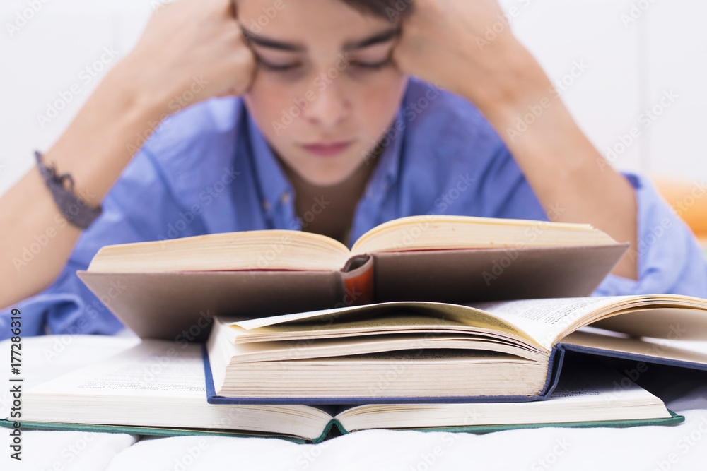 books in the foreground with young people studying, teaching and education books in the foreground with young people studying, teaching and education