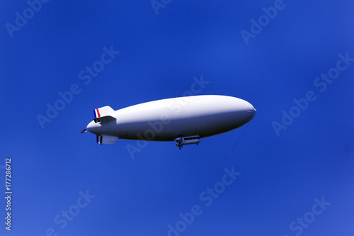 A zeppelin flying in the blue sky