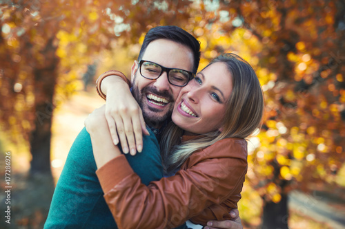 Couple in love in autumn.Smiling young couple hugging in the park.
