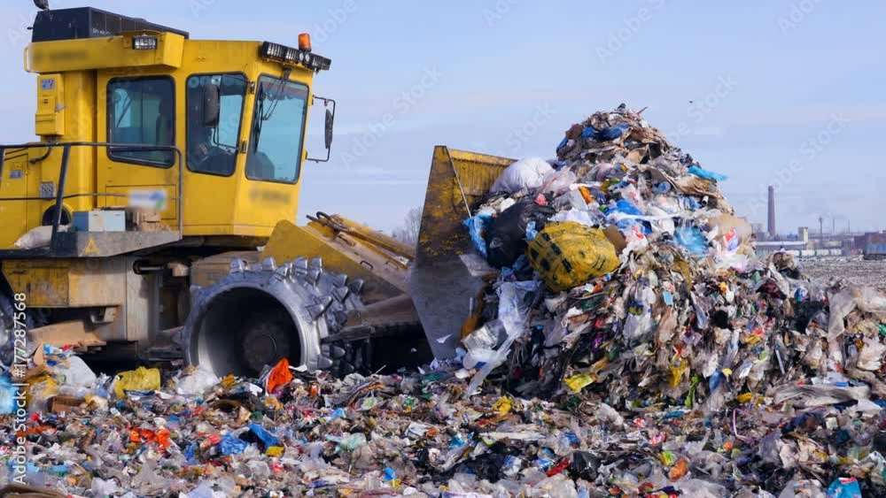 Landfill trash being moved by a bulldozer
