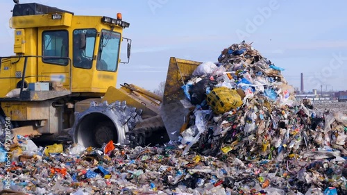 Landfill trash being moved by a bulldozer photo