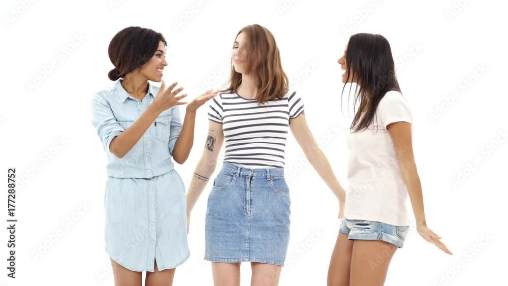 Young happy three girls friends gives a high-five to each other Young happy three girls friends gives a high-five to each other