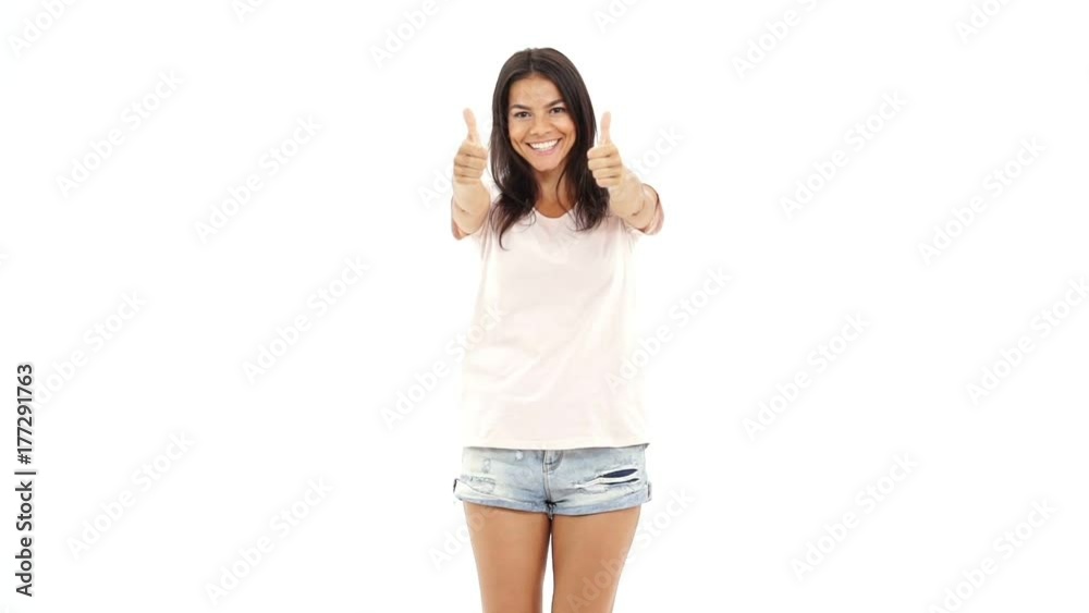Young cheerful caucasian pretty lady showing thumbs up and looking camera Young cheerful caucasian pretty lady showing thumbs up and looking camera