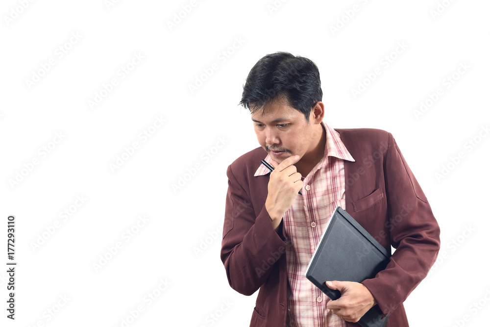 Asian businessman thoughtful and holding notebook on hands Asian businessman thoughtful and holding notebook on hands