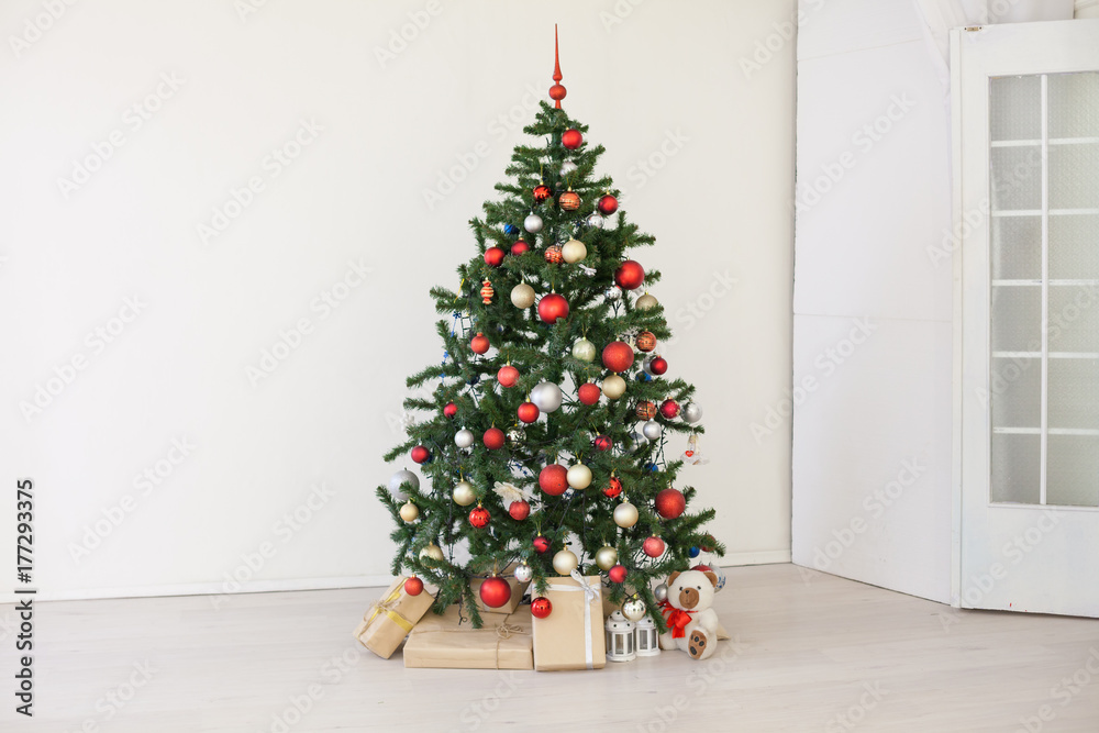 Christmas tree with red gifts in the white room Christmas