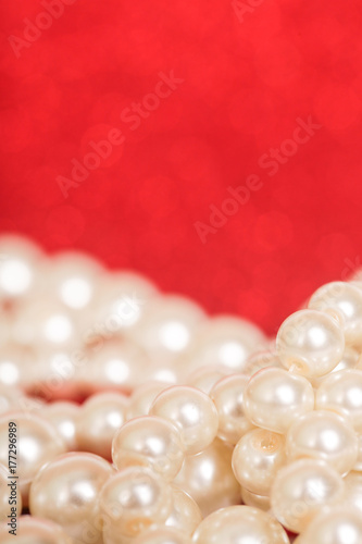 Pile of pearls on red christmas background