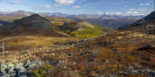 Fototapeta Naklejka Na Ścianę i Meble -  Ural autumn landscape - snow-capped peaks, mountain forests, yellow foliage, transparent cold rivers