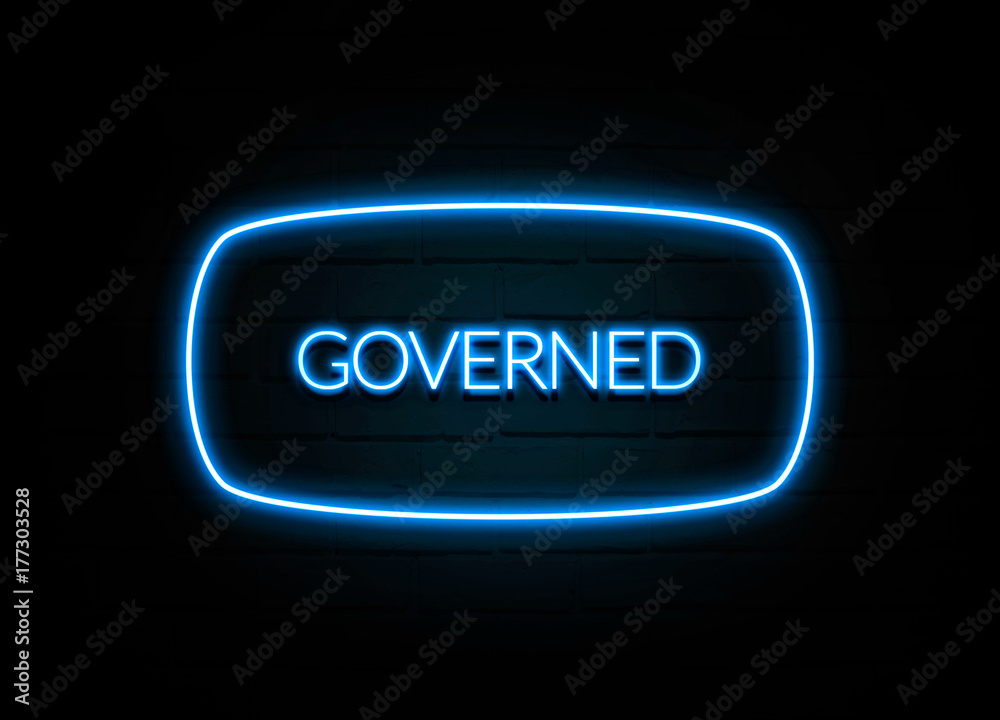 Governed  - colorful Neon Sign on brickwall