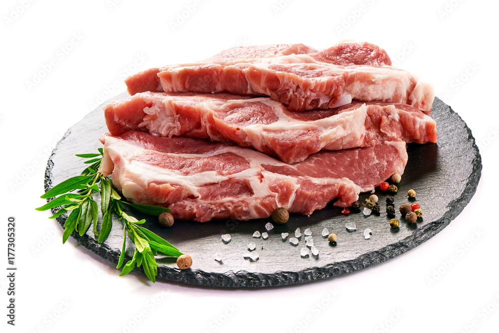 Raw sliced pork meat on stone board, isolated on white background
