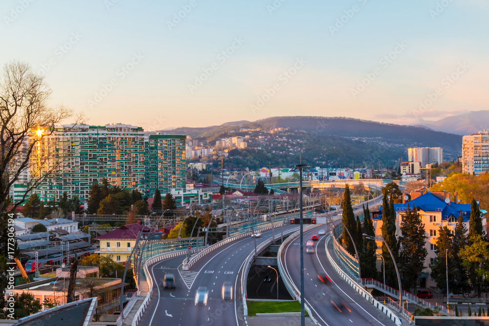 Fototapeta premium Aerial view of city, mountains and highway 