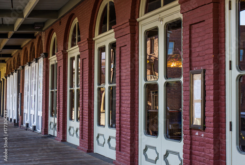 Wooden Sidewalk In Front Of Historic Building Doors © Tom