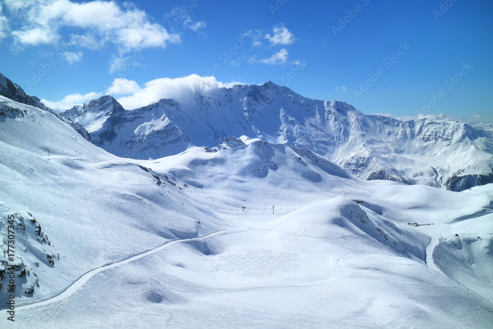 Winter mountain panorama with fresh snow on skiing tracks, Meribel slopes, 3 Valleys resort, Alps, France