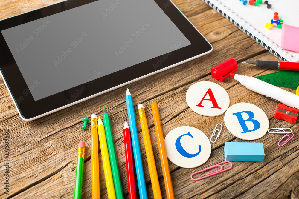 Naklejka premium Composite image of digital tablet on students desk showing back to school message