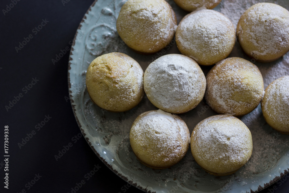 Tasty vanilla muffins on an ornamented plate Tasty vanilla muffins on an ornamented plate