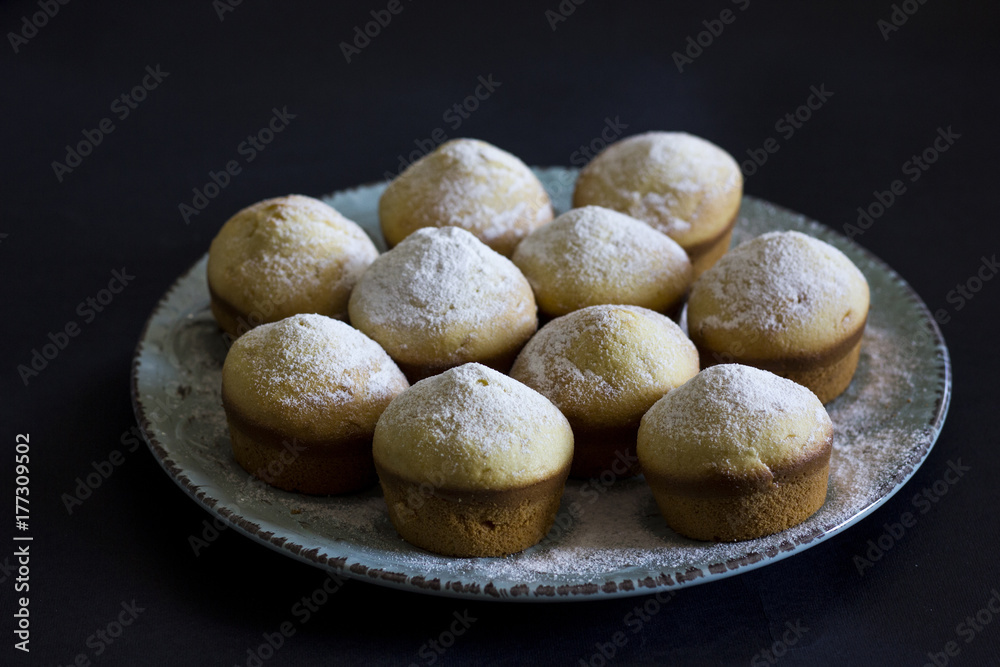 Tasty vanilla muffins on an ornamented plate Tasty vanilla muffins on an ornamented plate