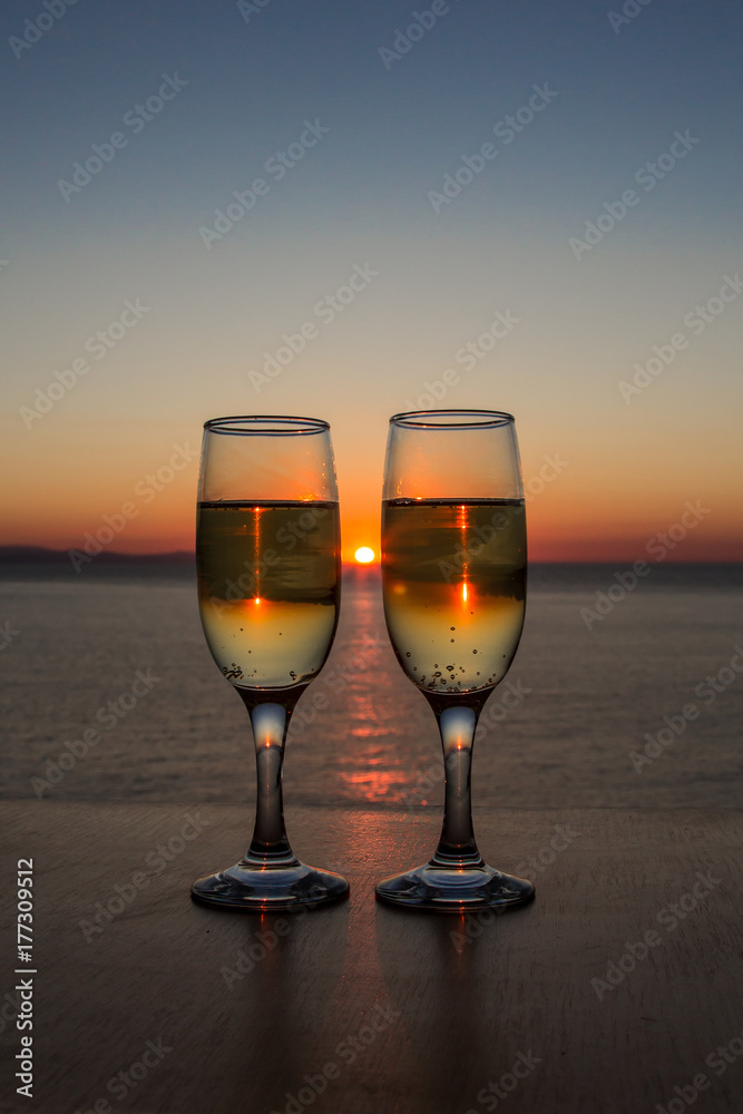 Two glasses of wine at sunset on the table