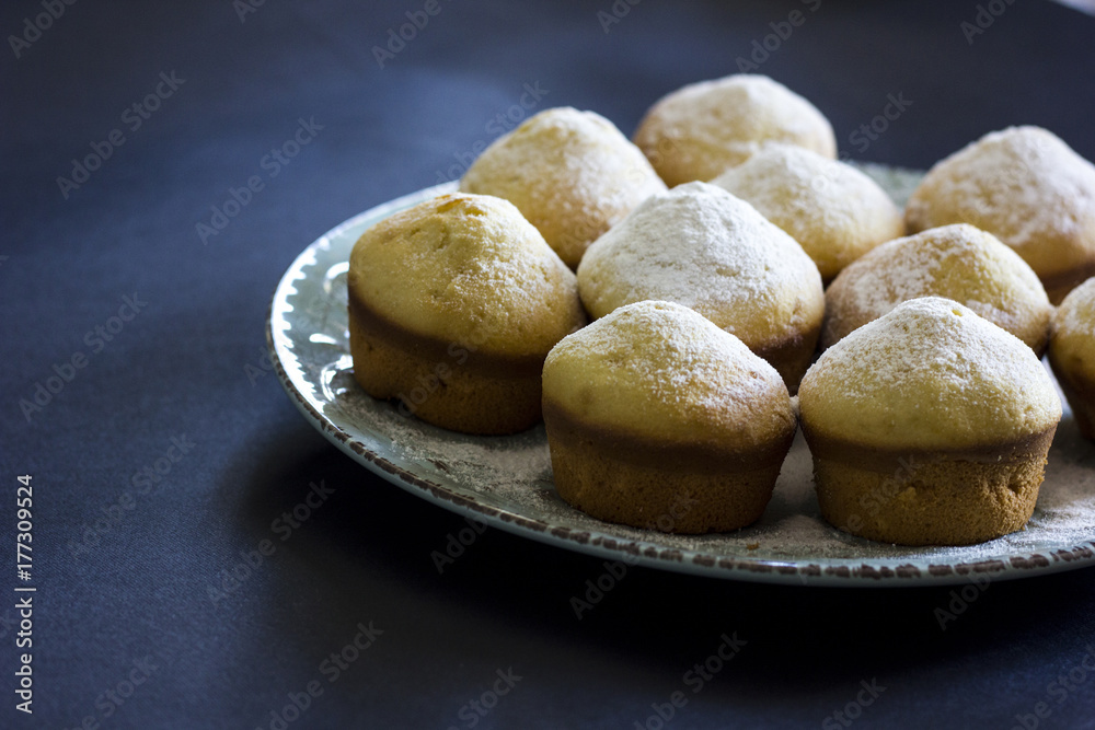 Tasty vanilla muffins on an ornamented plate Tasty vanilla muffins on an ornamented plate